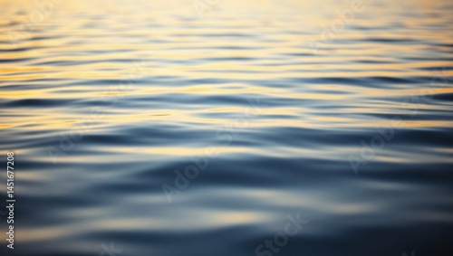 Gentle water ripples, soft sunset hues, close-up view.