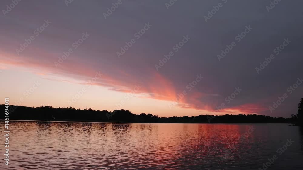 Dramatic sunset transition over tranquil lake with vibrant sky reflections Dramatic sunset transition over tranquil lake with vibrant sky reflections