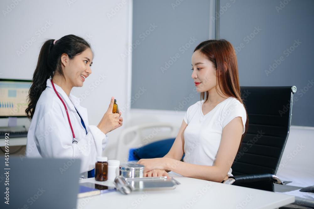 Asian Doctor and patient discussing something while sitting at the table . Medicine and health care concept. Doctor and patient Asian Doctor and patient discussing something while sitting at the table . Medicine and health care concept. Doctor and patient