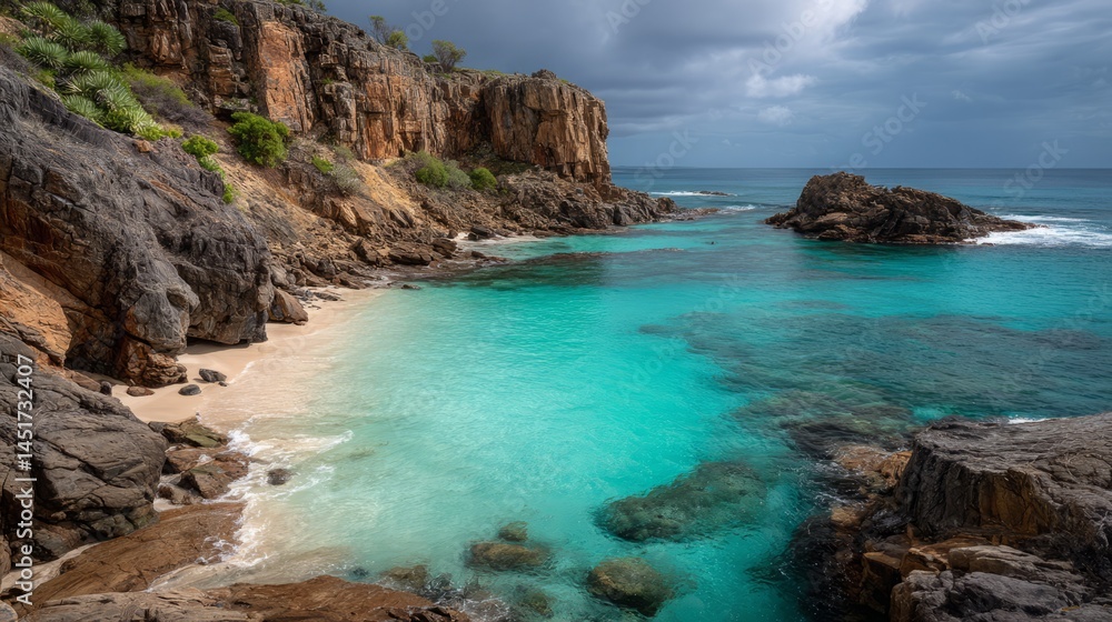 Obraz premium Secluded tropical beach cove with turquoise water and rocky cliffs scenery