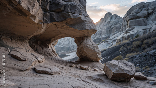 Majestic rock arch framing dramatic desert landscape at sunset
