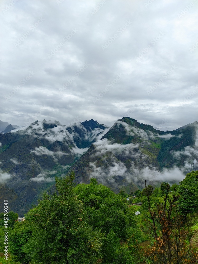 Fototapeta premium Misty Joshimath Mountain View: Scenic Himalayan Landscape with Fog and Greenery