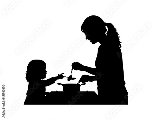 Silhouette of mother and child cooking together at kitchen counter
