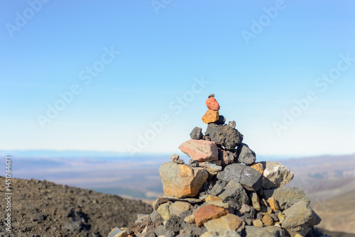 Obraz na płótnie Stone stack with red rock on top at Tongariro Alpine Crossing. Tongariro National Park. New Zealand. w salonie