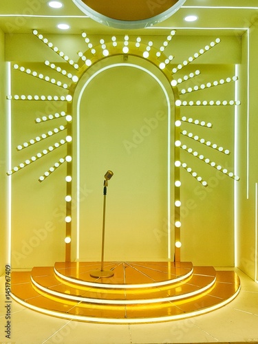 A stage with a golden platform, arched backdrop with radiating lights, and a microphone stand. A shining stage with a golden microphone in the center. Toned image. 
