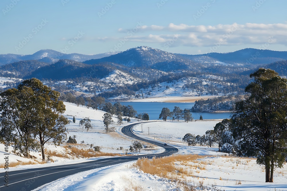 Obraz premium A Highway Passing Through a Snowy Mountain Landscape