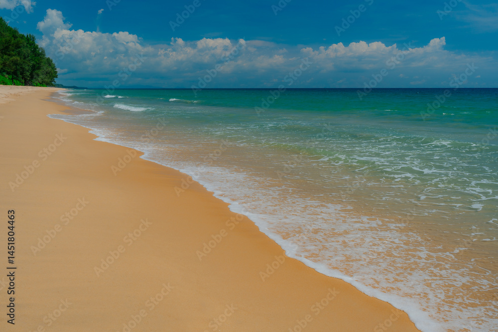 Fototapeta premium Minimalist surf study captured in razor-sharp detail: lace-fine foam traces a clean curve across warm, velvety sand as the water shifts from translucent aqua to deep sapphire on the horizon, offering 