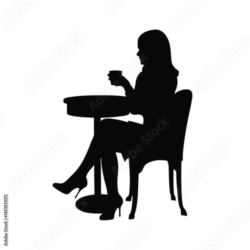 Silhouette of a woman sitting at a table enjoying a cup of coffee