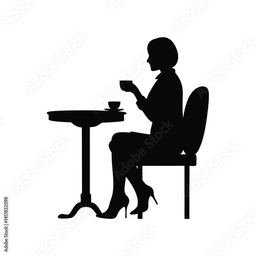 Silhouette of a woman sitting at a table enjoying a cup of coffee