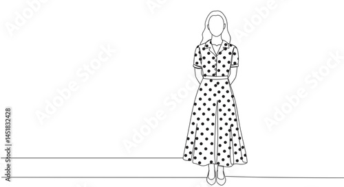 Elegant woman in polka dot dress standing against a white backdrop  