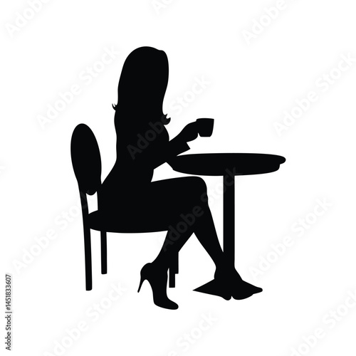 Silhouette of a woman sitting at a table enjoying a cup of coffee