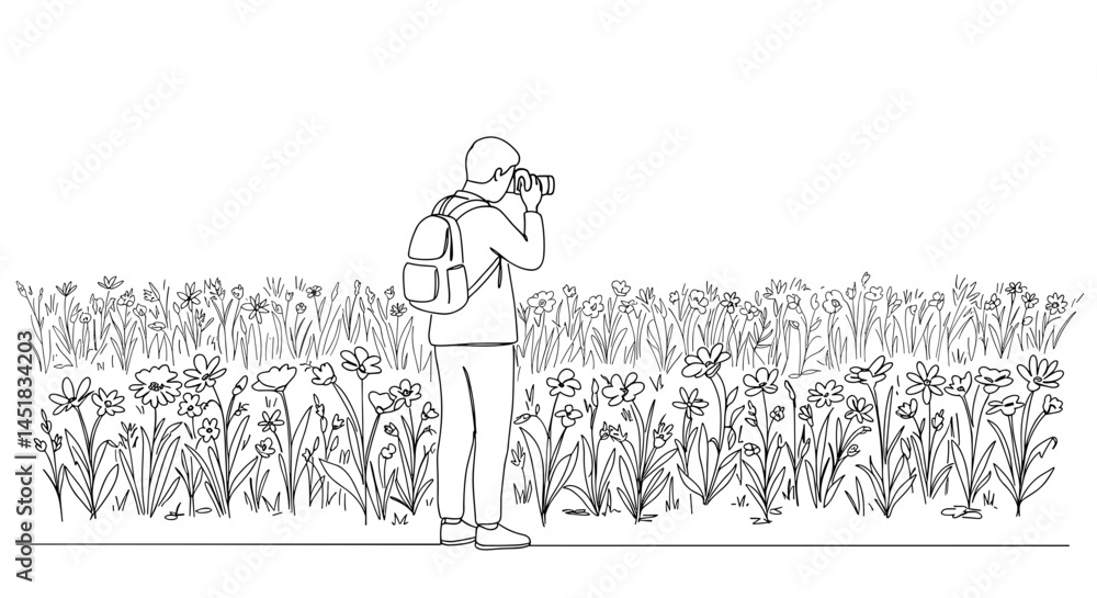 Person photographing flowers in a field
