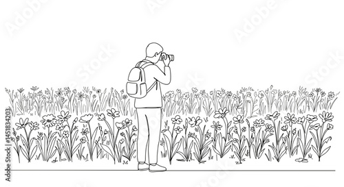 Person photographing flowers in a field  