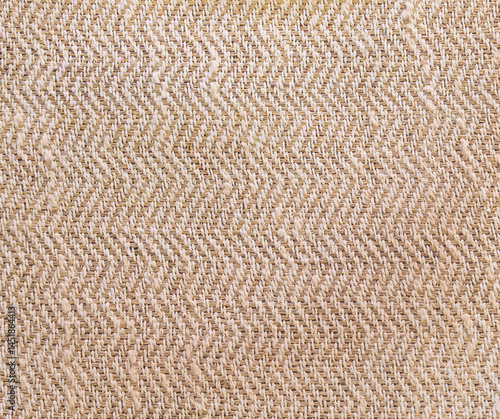 Texture of natural beige linen fabric with zigzag weave pattern background