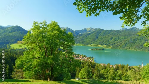 Calm mountain lake surrounded by green hills and forest near Schliersee, a summer paradise in southern Germany