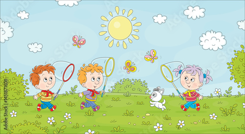 Happy little children playing, running, jumping and catching colorful butterflies with their toy butterfly nets on a green playground in a pretty park on fun summer vacations