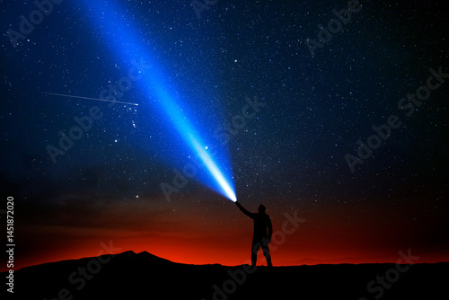 Illustration. A person shining a flashlight into the night sky