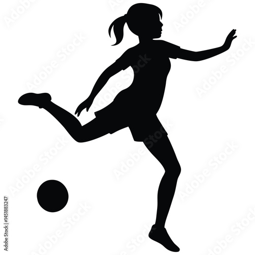 Silhouette of a young girl playing soccer, kicking the ball