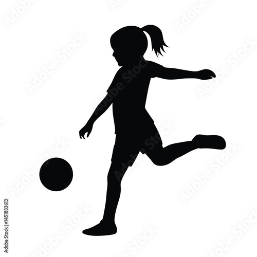 Silhouette of a young girl playing soccer, kicking the ball