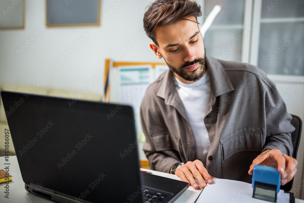 Man stamping an important document in the office. Man stamping an important document in the office.