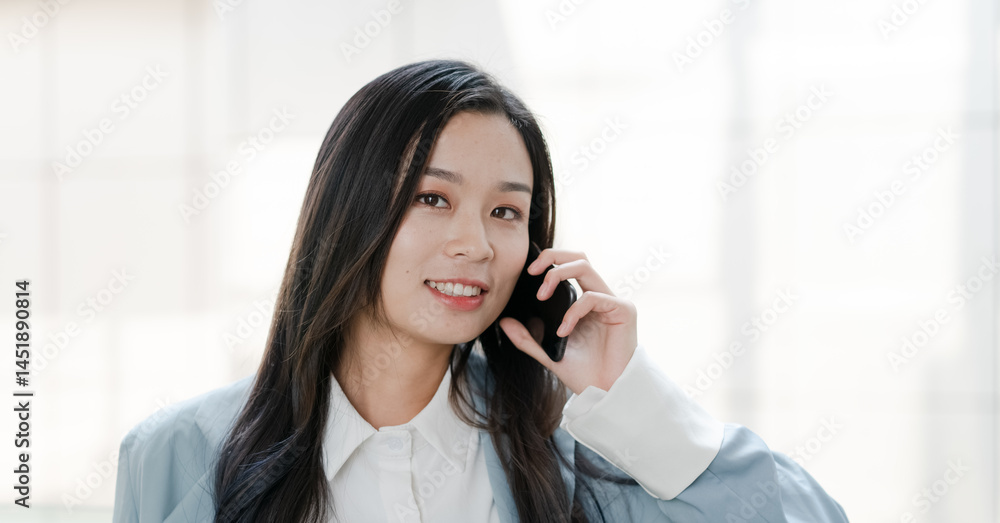 Asian woman talking on mobile phone