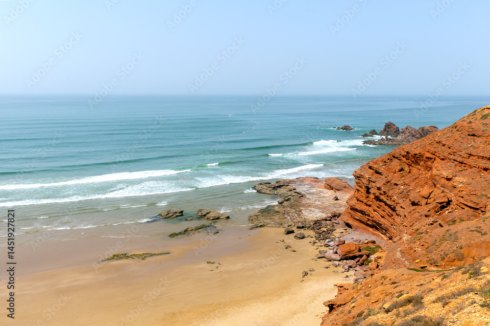 Picturesque red cliffs on shores of the Atlantic Ocean. Morocco Picturesque red cliffs on shores of the Atlantic Ocean. Morocco