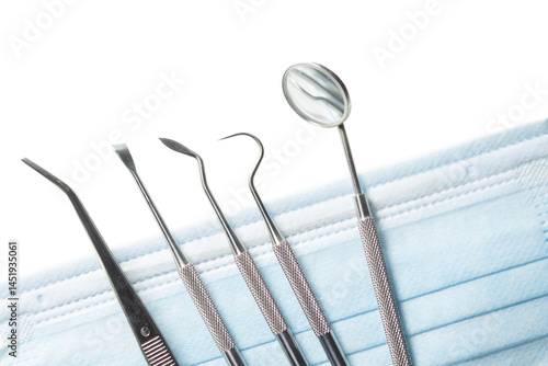 Dental tools set for dentistry inspection and face mask.