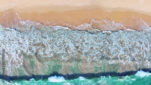 Beautiful sea summer landscape, Waves sea water surface High quality video ProRes HQ, Bird's eye view waves background, Drone top view waves crashing on sand beach,Nature ocean sea beach background