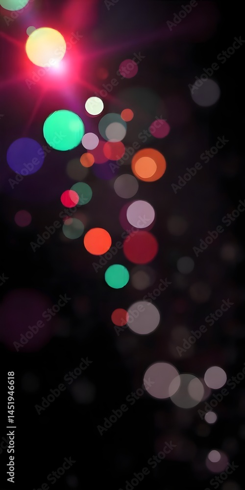 Obraz premium A vibrant array of bokeh lights in various colors and sizes illuminates a dark background