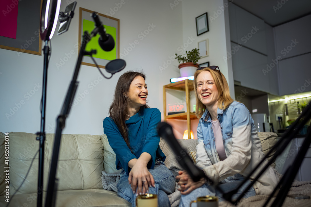 Fototapeta premium Creative teamwork: women recording a podcast in a cozy home setting.