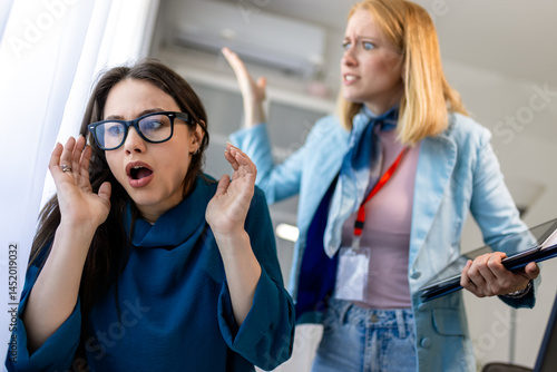 Photography Woman yelling at a colleague in an office, showing workplace bullying