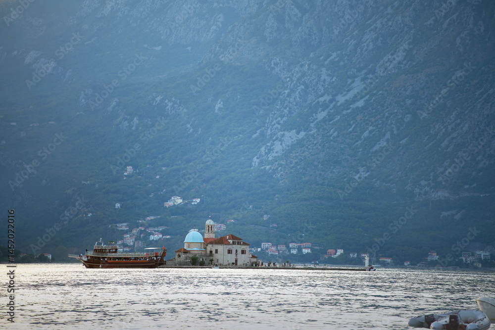 Monastery surrounded by trees on small island