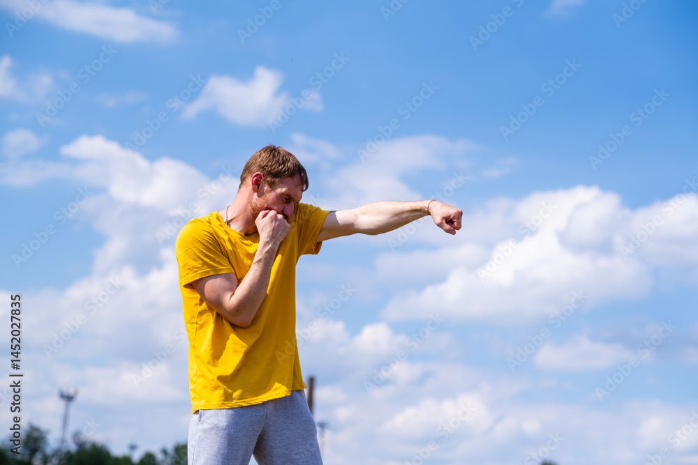 Man Practicing Boxing Moves in Scenic Park on a Sunny Afternoon Man Practicing Boxing Moves in Scenic Park on a Sunny Afternoon