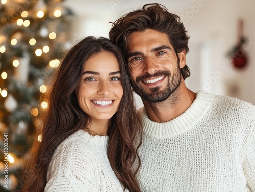 Happy couple by Christmas tree in cozy living room