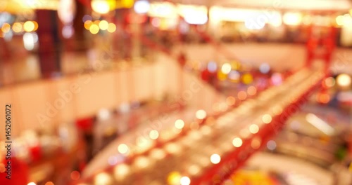 A blur of lights and color pulses through the busy mall, capturing the motion, energy, and festive glow of a vibrant shopping day.