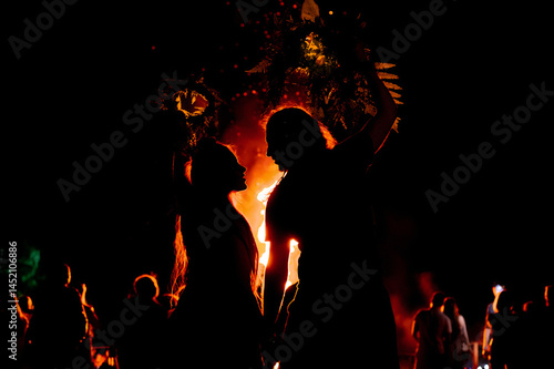 People dance in the firelight on Ivan Kupala