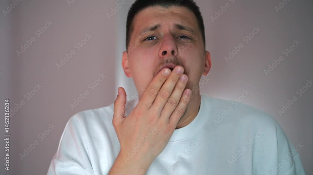 A sleepy man just woke up and yawns.
A man wants to sleep.
A tired guy in the bedroom before going to bed.
A tired face after a hard day.
An open mouth during yawning A sleepy man just woke up and yawns.
A man wants to sleep.
A tired guy in the bedroom before going to bed.
A tired face after a hard day.
An open mouth during yawning