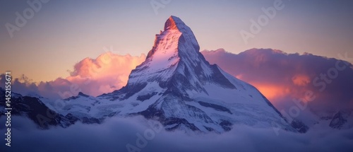 A mountain with a snow cap and a pink sky in the background