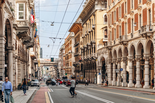 Fototapeta Naklejka Na Ścianę i Meble -  Genoa, Italy - September 22, 2024: Elegant arcaded facades and ornate historic buildings line Via XX Settembre, the city’s main shopping street.