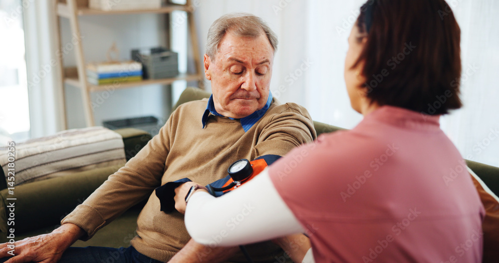 House, blood pressure and man with caregiver, testing or helping in apartment living room. Senior care, nurse or doctor with patient, trust or support for consulting elderly person or medical service