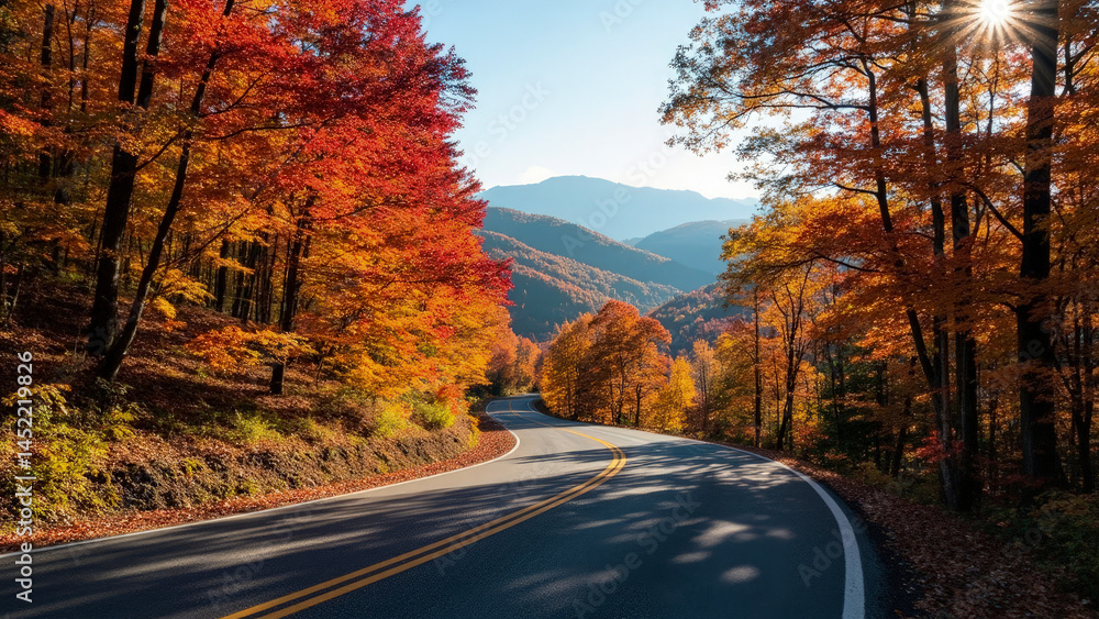 Naklejka premium Scenic winding road through vibrant autumn forest with colorful trees and mountains