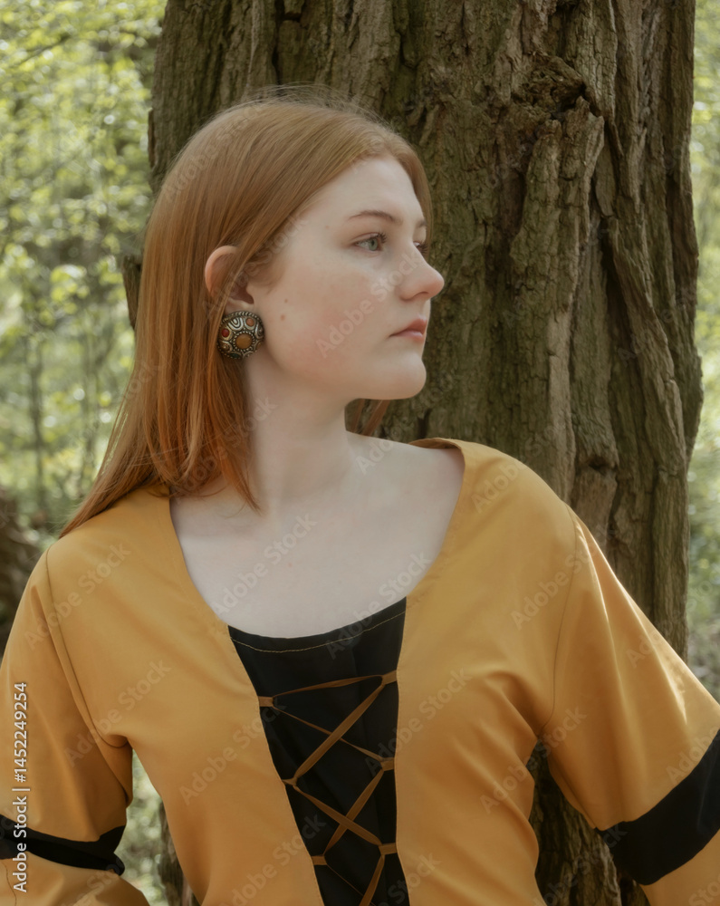 young woman in medieval dress in spring forest