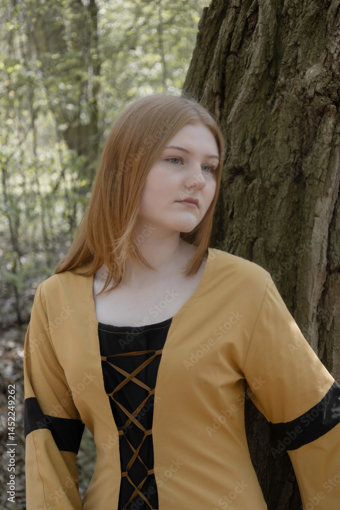 young woman in medieval dress in spring forest