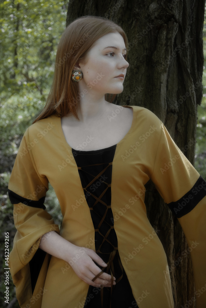 young woman in medieval dress in spring forest