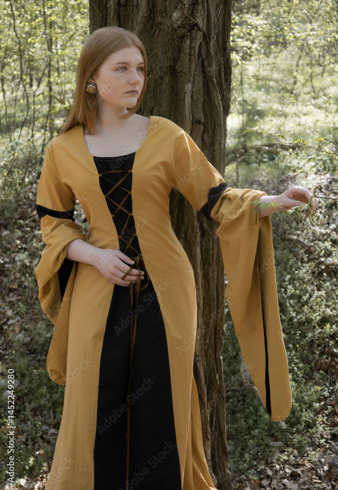 young woman in medieval dress in spring forest