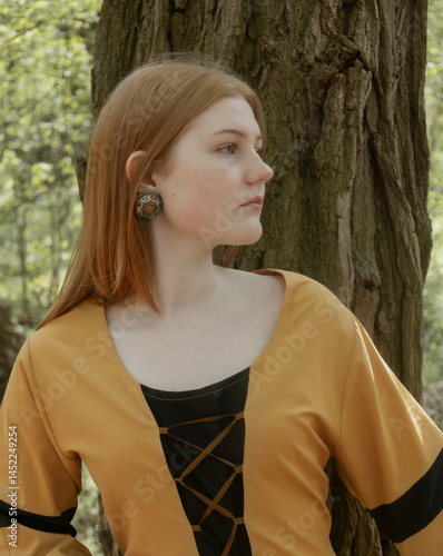 Obraz na płótnie young woman in medieval dress in spring forest w salonie