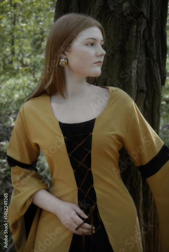 Obraz na płótnie young woman in medieval dress in spring forest w salonie