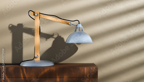 Office lamp standing on a wooden shawl against the wall. Retro or vintage style desk lamp, classic wooden arm with metal base and grey colored canopy.