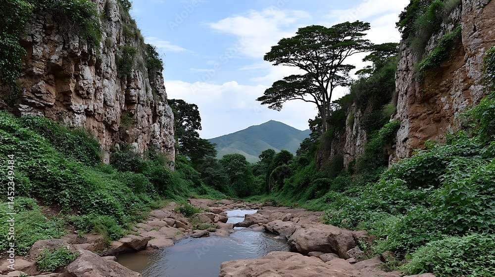 Obraz premium Serene Canyon Oasis Lush greenery with tranquil stream, and majestic mountains.