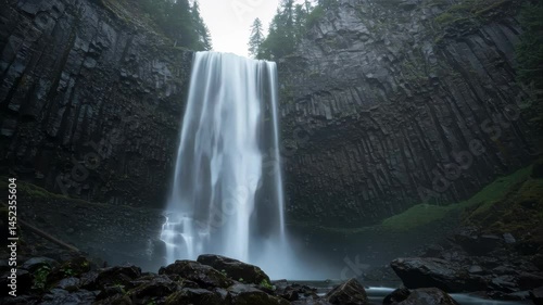 Serene Waterfall Cascading Down Dark Basalt Cliffs